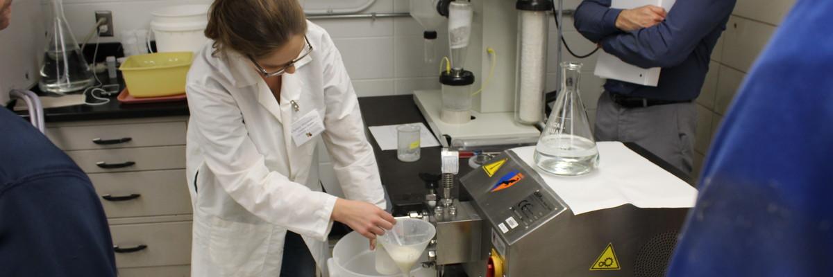 Chelsey Hinnenkamp, PhD candidate, demonstrates the two-stage homogenizer used to form emulsions