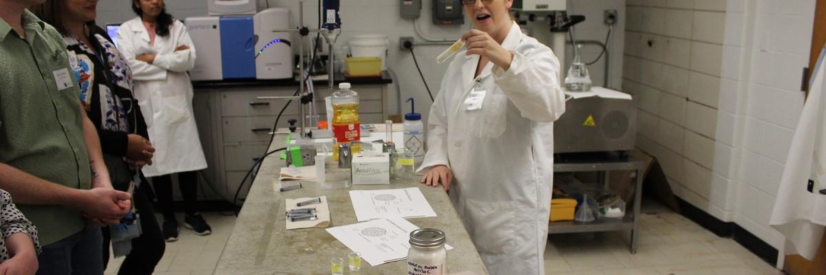 Chelsey Hinnenkamp, PhD candidate, holds up a whey protein isolate and fish oil emulsion. From there, she will use a spray-dryer to microencapsulate the polyunsaturated oil to prolong its shelf life